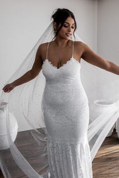 a woman in a white wedding dress and veil