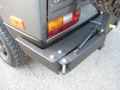 the back end of a vehicle with its bumper mounted on it's flatbed