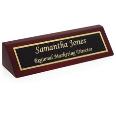 a red and black plaque with the name savannah jones regional marketing director written on it