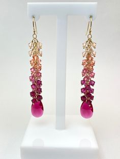 Elegantly designed handcrafted earrings made with authentic, 4mm light pinks to ruby Swarovski Crystals, finished with a ruby Swarovski pendant. *14k Gold Filled   Length: 3-inch drop Width: 10-12mm Storage bag and polishing cloth included. Fine Jewelry Pink Briolette Earrings, Pink Briolette Fine Jewelry Earrings, Pink Faceted Ruby Jewelry, Pink Briolette Ruby Jewelry, Pink Ruby Dangle Jewelry, Pink Ruby Dangle Earrings, Swarovski Pendant, Ethiopian Opal Ring, Making Earrings