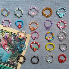 many different colored beads and bracelets are laying on the table next to a photo