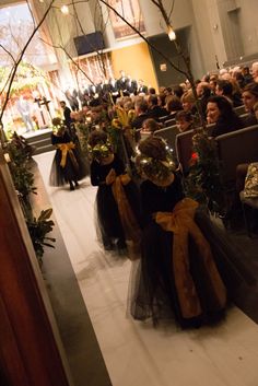 a group of people sitting in pews next to each other at a wedding ceremony