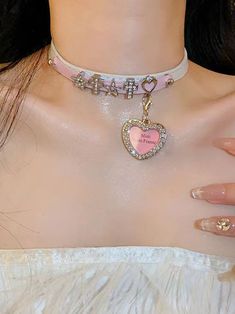 This pink and white PU choker comes in two styles for you to choose from. One features decorations of stars, hearts, a cross, and a heart pendant, while the other features heart and star decorations with a star pendant. Both options are perfect for adding a touch of sweetness and charm to your outfit. Made with high-quality materials, these chokers are perfect for anyone who loves Lolita or kawaii fashion. Add a whimsical and adorable touch to your look with these lovely chokers.  The price is for a choker only, others are not included. Pink Heart-shaped Choker For Valentine's Day, Trendy Pink Jewelry With Star Charm, Personalized Pink Kpop Style Jewelry, Pink Star Charm Jewelry, Pink Heart Beads Choker Jewelry, Pink Heart Charm Choker Necklace, Chokers Aesthetic, Mini Photo Frames, Steampunk Fashion Male