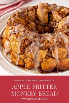 an apple fritter monkey bread on a white plate with cinnamon glaze drizzled over the top