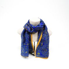 Royal blue is matched with gilt gold to produce an elegant design of detailed line-work. Let others revel at your royal scarf, as you relish the rightful admiration over your fine fashion taste. Inspiration: Poetical Works of Byron, c.1900 Vintage Blue Silk Scarf As Gift, Vintage Blue Silk Scarf For Gift, Blue Vintage Silk Scarf For Gift, Elegant Ceremonial Shawl, Classic Gold Silk Scarf, Vintage Blue Silk Scarf For Formal Occasions, Blue Vintage Silk Scarf For Formal Occasions, Blue Traditional Scarves For Festive Season, Traditional Blue Scarf As Gift