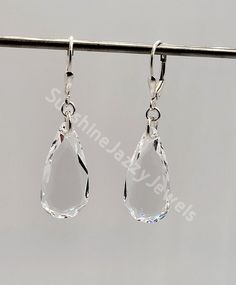 These beautiful sterling silver earrings have sparkling Swarovski Crystal Clear Teardrop pendants hanging from a closure of your choice. Choose Closure: Fishhook Earwire or Leverback (925) Earwires come with rubber earnut backs in order to secure them on your ears; leverback have a secure attachment. Shape: Teardrop 6140 - beautiful faceted edges for a very elegant look Color: Clear Pendant Size: 24x12 Total earring length: approx. 2" Packaged in a cotton filled gift box Classic Teardrop Crystal Earrings, Classic Sparkling Teardrop Crystal Earrings, Classic Silver Hypoallergenic Crystal Earrings, Sparkling Sterling Silver Teardrop Earrings, Teardrop Crystal Earrings With Ear Wire, Gift Sterling Silver Pear-shaped Crystal Earrings, Faceted Crystal Teardrop Earrings, Pear-shaped Sterling Silver Crystal Earrings For Gifts, Sparkling Sterling Silver Drop Crystal Earrings