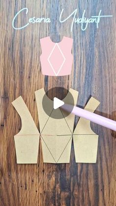 an origami piece being cut out to look like a woman's dress