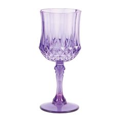 a purple wine glass sitting on top of a table