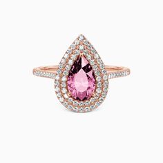 a pink tourmaline and white diamond ring with an open pear shaped center surrounded by smaller round diamonds