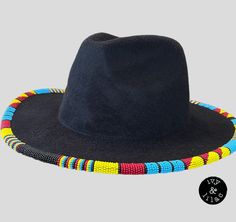 Native American beaded fedora in blue, red, yellow and black beads. Hundreds of size 11 beads rim this hat in a geometric pattern. Desire your own color combination? Reach out for a custom piece. Multicolor Bead Caps Festival Hats, Multicolor Bead Caps Hats For Festival, Multicolor Bead Cap Hats For Festivals, Multicolor Bohemian Hat With Bead Caps, Multicolor Beaded Caps Festival Hats, Multicolor Festival Hats With Bead Caps, Festival Multicolor Beaded Hats, Traditional Multicolor Beaded Hat, Traditional Multicolor Fedora Hat