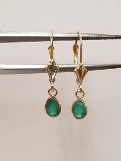 "Thanks for shopping our vintage estate store. We tend to sell well below wholesale and truly hope you enjoy all of our items. Many of the items are one of a kind, so please enjoy scrolling through the pictures and hopefully something will catch your eye. Brown spots are from camera or reflections. Nice estate 14k yellow gold natural .50ct emerald tear drop lever back earrings.  Length: 7/8\" Width: 1/4\" 4.5mm Weight: .92 gram Gem: 6mm by 4mm Beautiful earrings, marked 14k." Classic Lever Back Jewelry For Anniversary, Classic Teardrop May Birthstone Earrings, Teardrop Lever Back Jewelry For Anniversary, Classic Teardrop Earrings For May Birthstone, Classic 14k Gold Earrings For May Birthstone, Classic Pear-shaped May Birthstone Earrings, Classic 14k Stamped Pear-shaped Jewelry, Classic Pear-shaped 14k Stamped Jewelry, Classic Teardrop Lever Back Jewelry