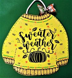 an ornament that says weather weather with a pumpkin on it