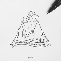 the hogwarts is my home logo on a piece of paper next to a pen