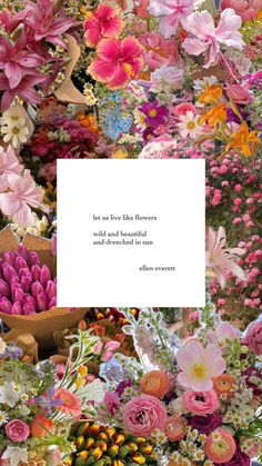 a bunch of flowers that are next to a white paper with a quote on it