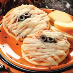 an orange plate topped with cookies covered in googly eyes