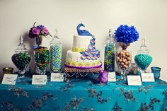 a table topped with lots of different types of candies and cake on top of it