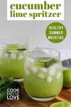 two mason jars filled with cucumber and mint water on top of a wooden table