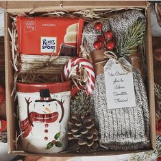 a christmas gift box with coffee mugs, candy canes and other holiday items