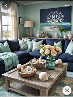 a living room filled with blue couches and lots of pillows on top of it