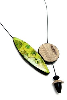 two pieces of art hanging on a string with wood and glass beads, one piece has a wooden disc attached to it