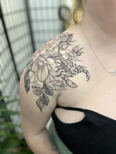 a woman with a flower tattoo on her shoulder