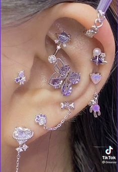 the ear is decorated with purple and white jewels