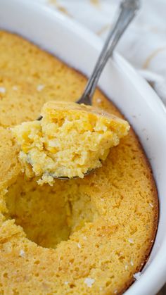 a close up of a cake in a pan with a spoon sticking out of it