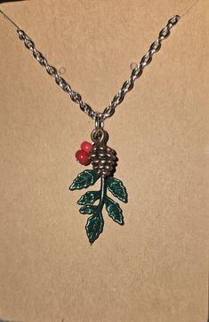 This is a pendant holly berry and pinecone necklace on a 20" stainless steel chain.  It's the perfect festive touch to your holiday outfit! Berry Necklace, Pinecone Necklace, Holly Berry, Holiday Outfit, Steel Chain, Stainless Steel Chain, Pine Cones, Holiday Outfits, Pendant Necklaces