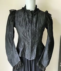 "Victorian Waist, Jacket, Black Figured Cotton Mourning Jacket Gorgeous antique Victorian waist jacket with self gathered collar,Princess seams going into a nice nice V  front and back, leg of mutton sleeves trimmed with black gathered lace and black gathered lace over the shoulders and around the back.  The inside seams are sewn by hand and it would of had three pieces of boning at one time . This would look great worn with jeans, slacks or a skirt. MEASURES: Bust - 34\"  Waist - 32\"  shoulder Black Costume Blazer For Fall, Black Blazer For Fall Costume Events, Black Blazer For Fall Costume, Victorian Fitted Outerwear For Fall, Victorian Fitted Fall Outerwear, Black Victorian Long Sleeve Outerwear, Fitted Victorian Black Outerwear, Fitted Black Victorian Outerwear, Fitted Victorian Long Sleeve Outerwear