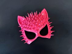 Step into the world of sleek enigma with our sexy cat mask inspired by Cat Woman. This mask will give your look a touch of seductive charm and edgy allure. The spikes add a hint of danger and edginess, reflecting the fierce and enigmatic nature of the feline spirit. Glide through cosplay events or Halloween costume parties as a seductive figure, leaving a trail of admiration in your wake. Age Group/Gender - Adult/Women Size/Type - One size fits all adults Mask Color - Pink Mask Material - Polyre Punk Style Cat Ear Party Accessories, Punk Cat Ears Costume Accessories For Party, Punk Eye Mask For Party, Punk Style Cat Ears Costume Accessories For Party, Punk Style Eye Mask For Party, Punk Style Party Mask Costume Accessories, Novelty Eye Mask For Parties, Novelty Eye Mask For Party, Novelty Cat Design Costume Accessories For Party