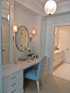 there is a vanity with a mirror and chair next to it in the bathroom area