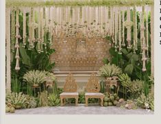 an outdoor wedding setup with white flowers and greenery on the wall, two wooden benches