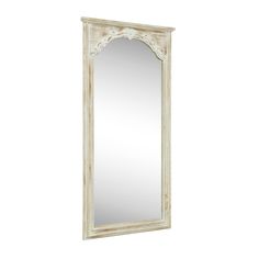 a white mirror sitting on top of a wall