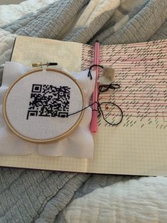 a cross - stitch book with a qr code on it and a pair of scissors