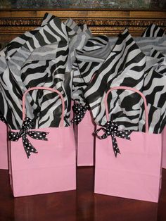 two zebra print bags with black and white polka dots on them, tied to each other