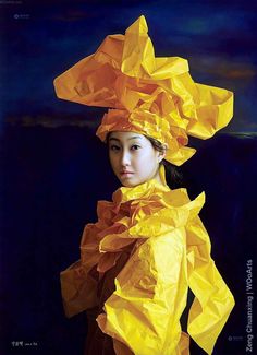 a woman with yellow paper on her head and dress made from orange sheets, standing in front of a dark background