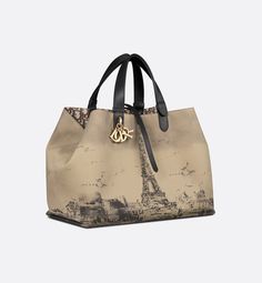 Large Dior Toujours Bag Beige and Black Water-Repellent Fabric with Paris Print | DIOR Dior Canvas Bag, Dior Star, Icon Shoes, Dior Book Tote, Paris Print, Beige And Black, Wallet Pouch, Backpack Tote Bag, The Eiffel Tower