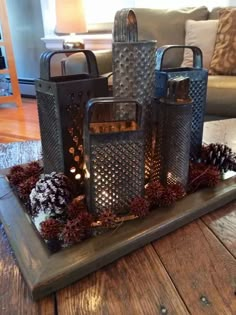 a tray with candles and pine cones on it