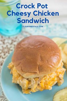 crock pot cheesy chicken sandwich on a blue plate with cucumbers