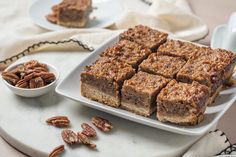 some pecan bars are on a white plate