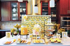 the table is set up with food and drinks for guests to enjoy in the kitchen