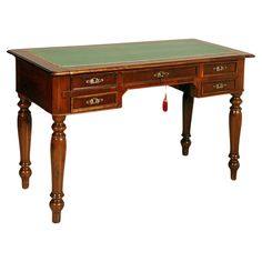 an antique desk with green leather top and wooden legs, on a white background the table is made of wood