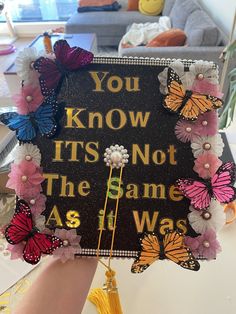 a graduation cap decorated with butterflies and the words you know it's not the same as i was