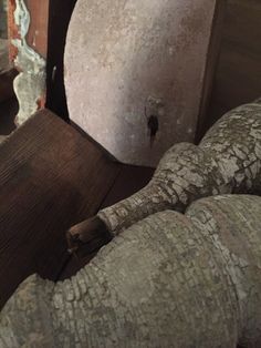 an elephant statue sitting on top of a wooden floor next to a wall and window