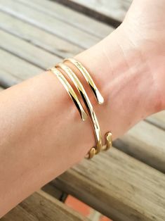 "Create your own set by choosing your size and number of bangles at checkout. Each bangle is just over 1/8\" wide and is made from jeweler's brass. These are slightly wider than our hammered brass bangles. They are very similar in color to 14k gold. Each bangle has been shaped and polished to sparkle. They are not connected, so they \"clink\" on your wrist. They are easily adjustable. Just pull open or squeeze closed for the perfect fit. Jewelers brass is an alloy made of 85% copper and 15% zinc Bronze Brass Bangle Bracelet, Gold-tone Brass Bangle As Gift, Adjustable Bronze Brass Bangle, Nickel-free Brass Bangle, Gold-tone Brass Bangle, Gold Holiday, Brass Bangle, How To Clean Metal, Brass Bracelet