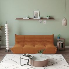 a living room with an orange couch and coffee table on the rug in front of it