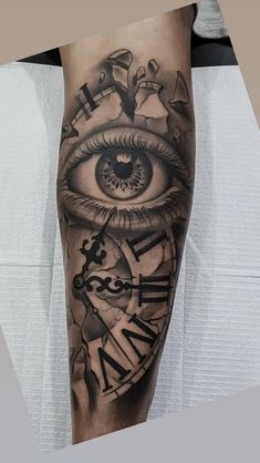 a man's leg with an eye and clock on it