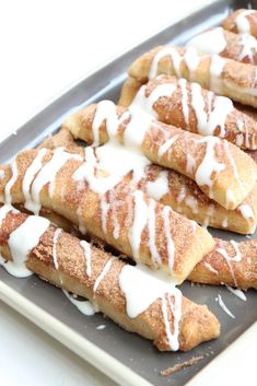 several cinnamon bread sticks with white icing on top and the words copycat pizza hut cinnamon bread sticks