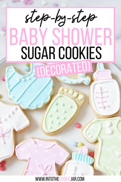 baby shower sugar cookies decorated with royal icing and sprinkles on a white plate