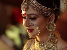 a woman with makeup and jewelry on her face